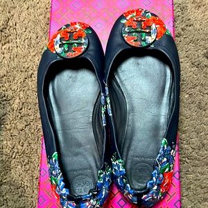 Tory Burch mini travel flat. It’s a deep blue with many other colors popping out